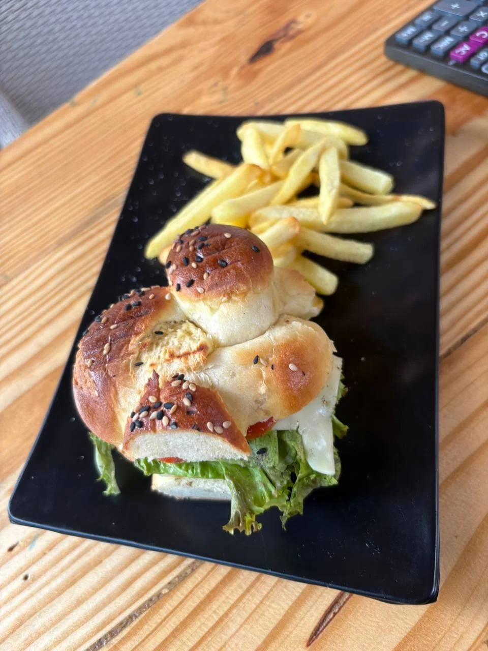 A burger and fries served at the Half Orange cafe