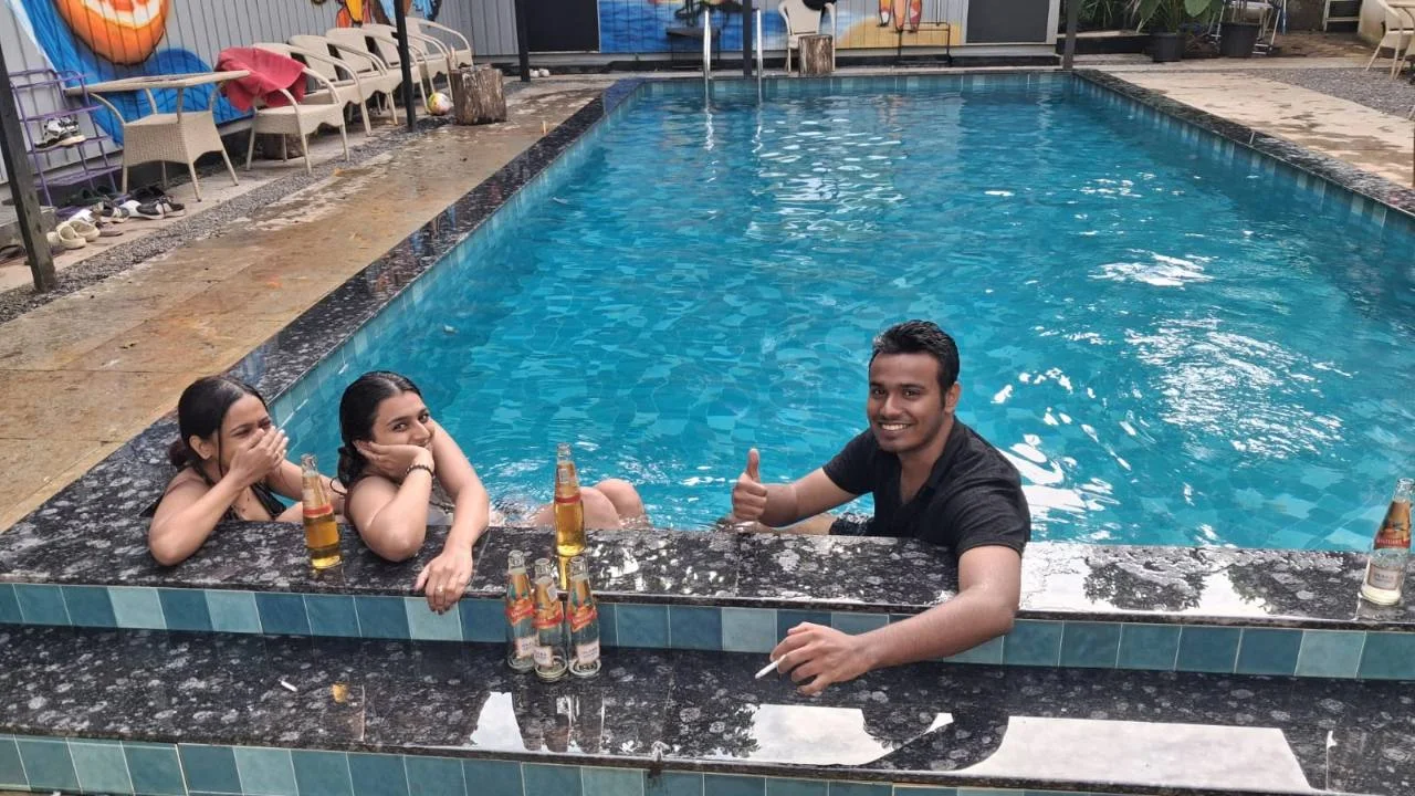 Friends spending time together in the outdoor pool at Half Orange