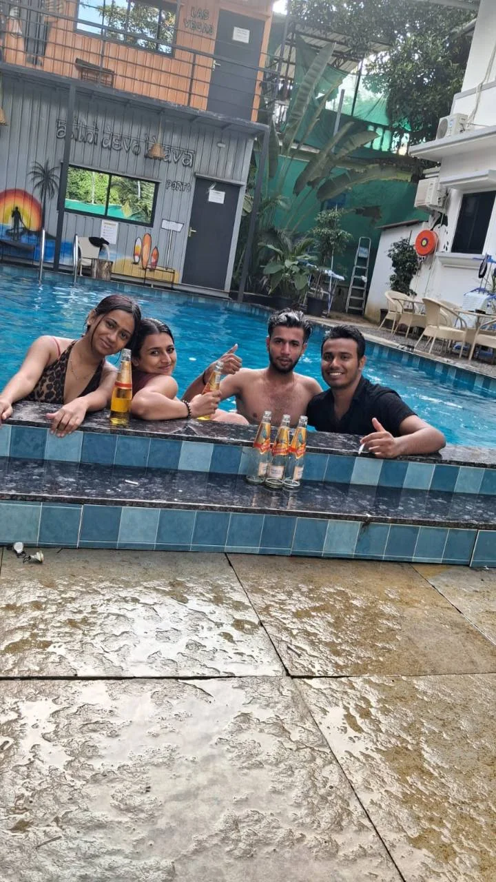 A group of friends enjoying the outdoor pool at Half Orange