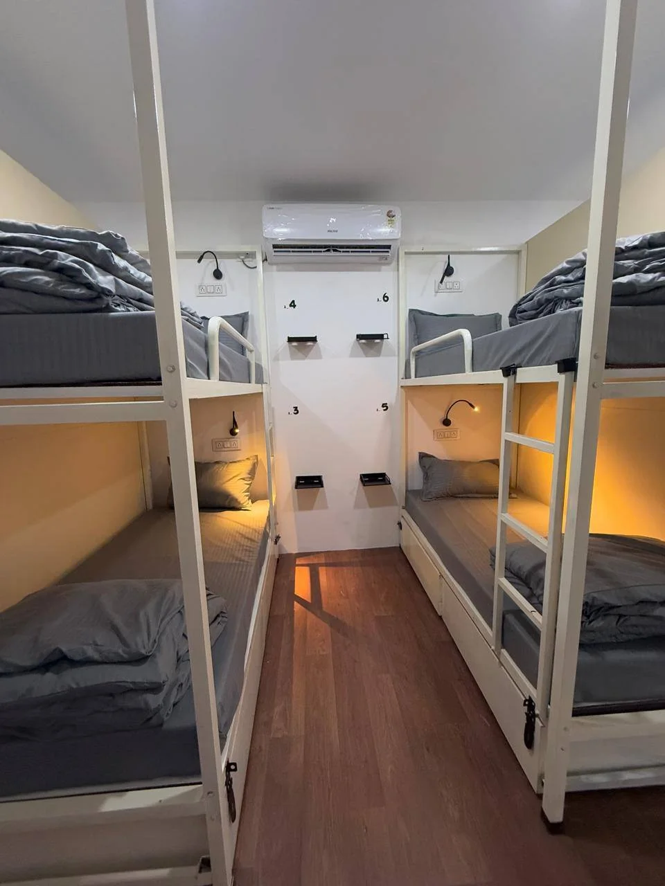 Four-bed dormitory with two bunk beds, reading lights and air conditioning at Half Orange