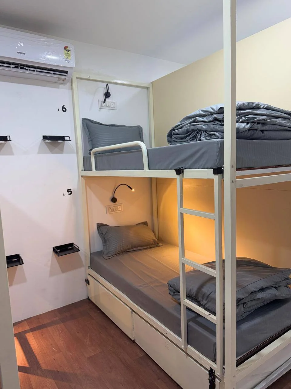 Bunk beds and ladder inside the four-bed dormitory at Half Orange