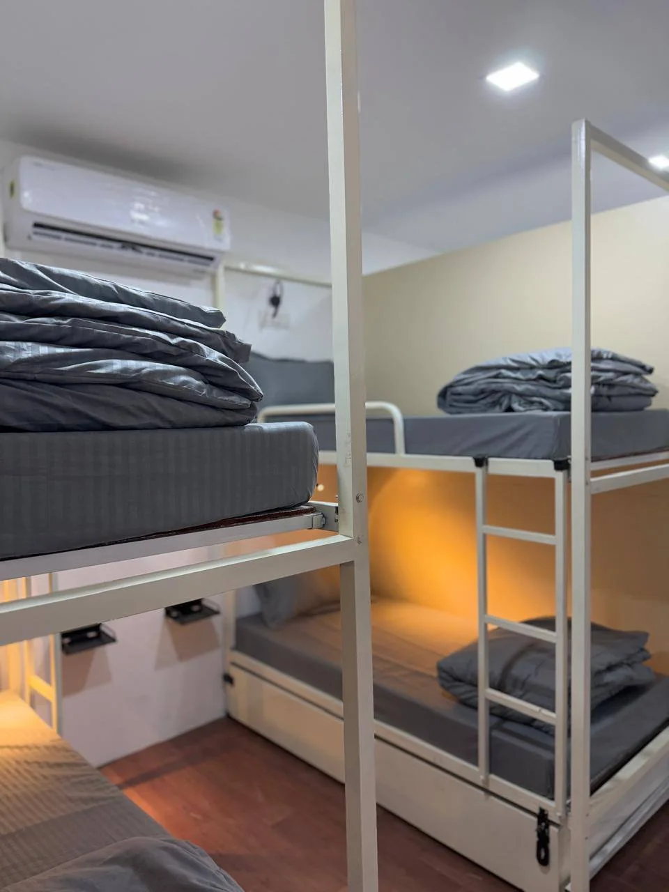Air-conditioned four-bed dormitory interior at Half Orange in Vagator