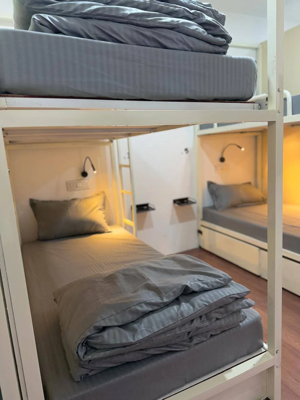 Prepared dormitory beds with individual lights at Half Orange