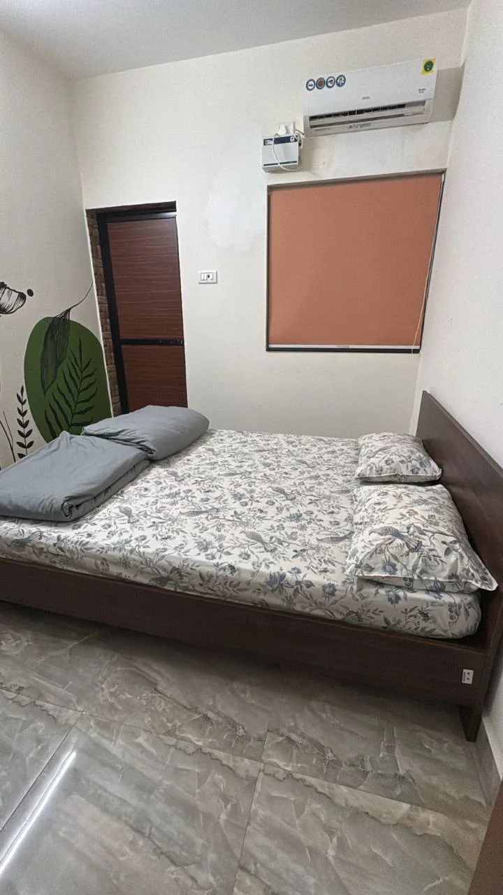 Deluxe private room with a queen-size bed and air conditioning at Half Orange