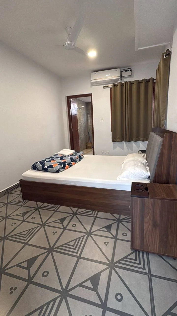 Deluxe Room with a queen-size bed, air conditioning and attached bathroom at Half Orange