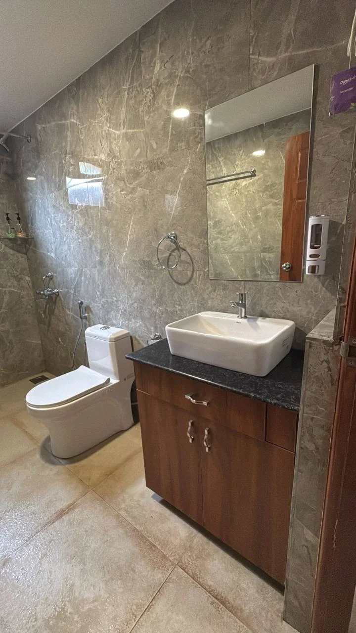 Attached bathroom with vanity in the Premium Deluxe Room at Half Orange
