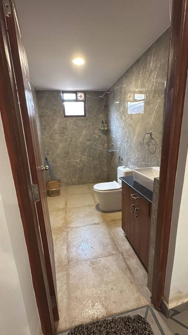 Spacious attached bathroom with shower and vanity in the Premium Deluxe Room at Half Orange