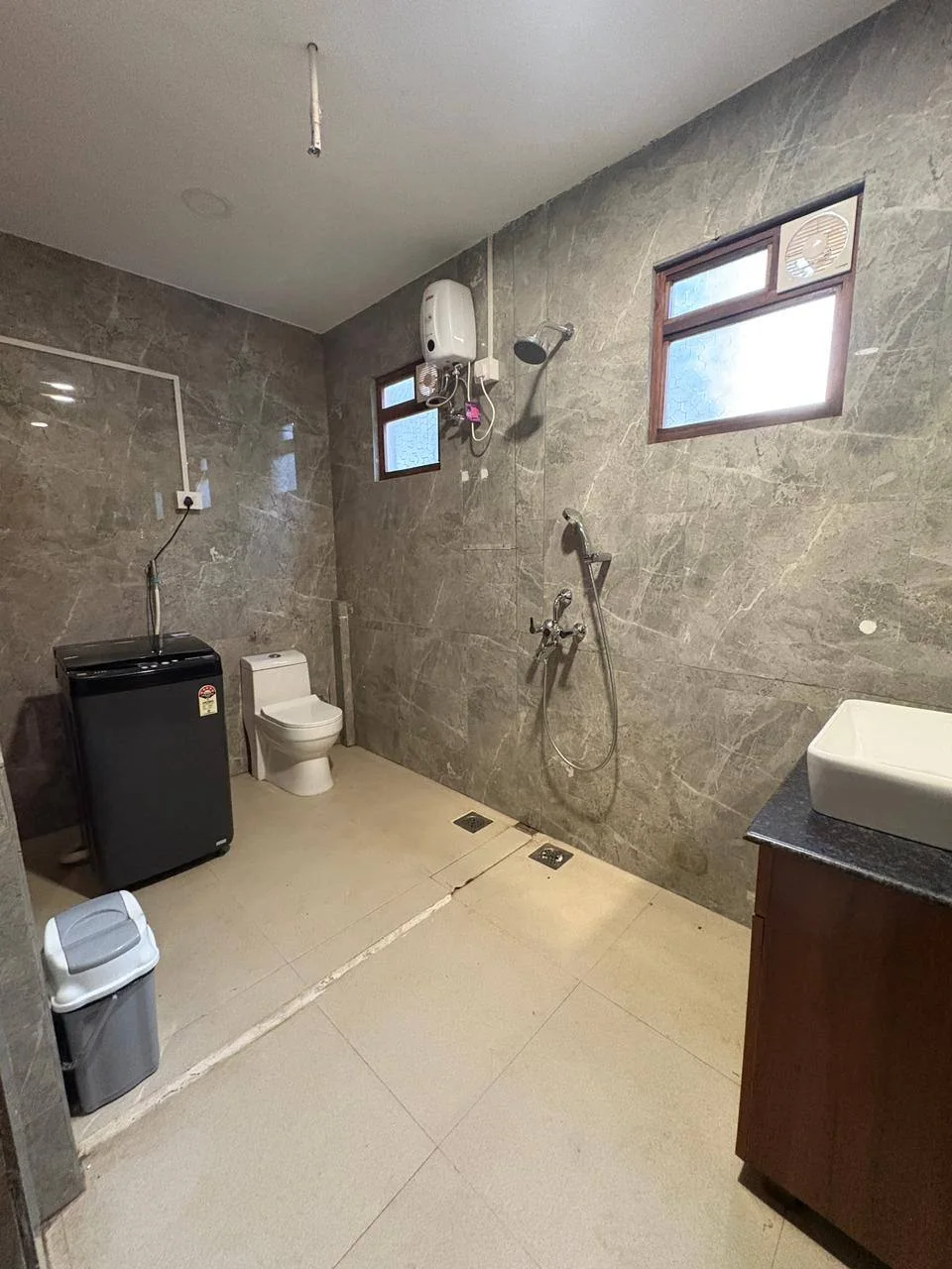 Premium Deluxe attached bathroom with shower, hot-water geyser and washing machine at Half Orange