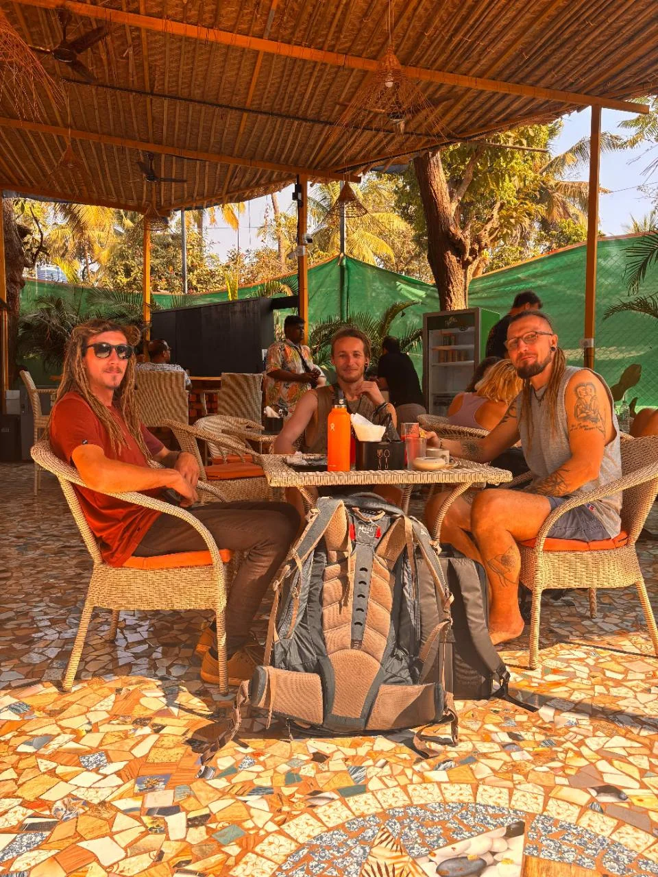Travellers relaxing together in the open-air cafe at Half Orange